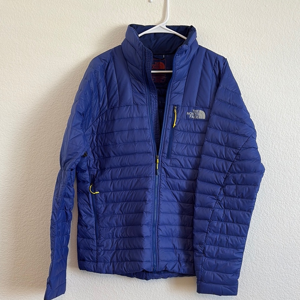 The North Face Blue Puffer Jacket with Quilted Design and Stand-Up Collar
